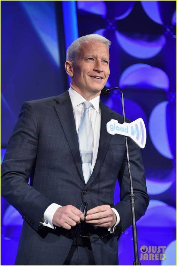 Anderson Cooper accepting GLAAD awards from Madonna