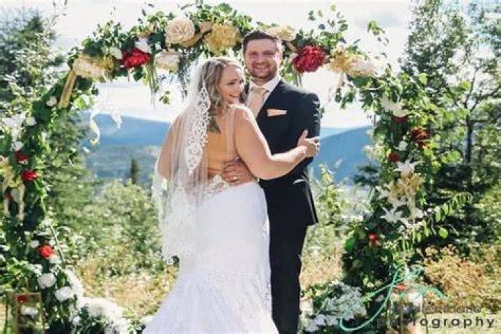 Monica Beets with her husband Taylor Maynes laughing and having a good times at their wedding
